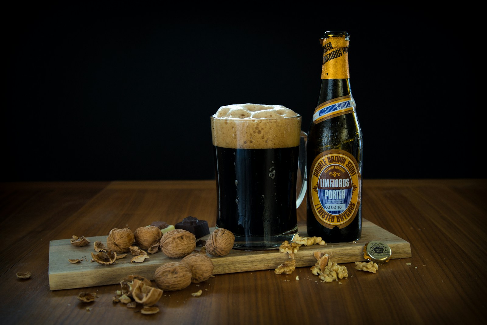 a bottle of beer next to a glass of beer